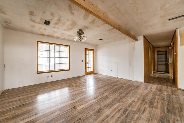 spare room with beamed ceiling, ceiling fan, and dark hardwood / wood-style flooring