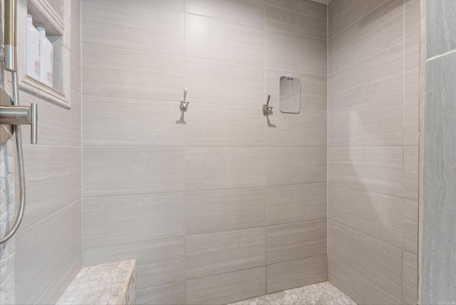 bathroom with tiled shower