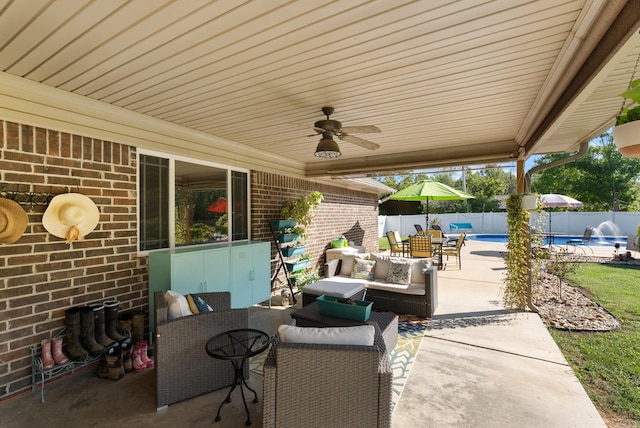 view of patio / terrace featuring an outdoor living space, ceiling fan, and a fenced in pool