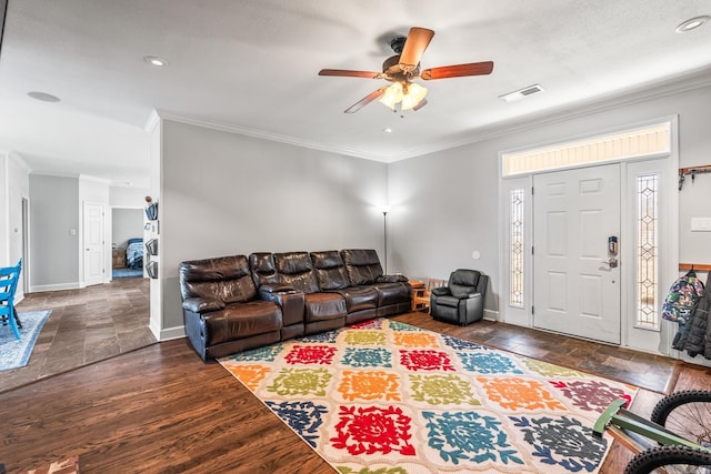 living room with dark wood-type flooring, ceiling fan, and ornamental molding