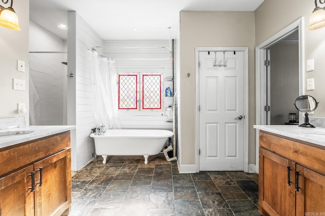 bathroom with a tub to relax in and vanity