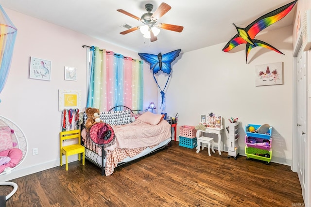 bedroom with dark hardwood / wood-style floors and ceiling fan