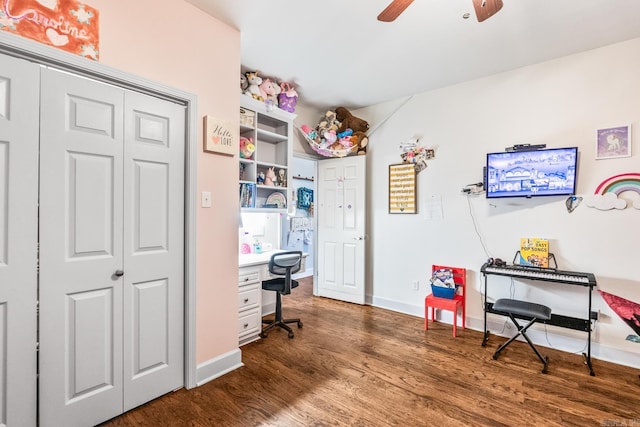 home office with dark hardwood / wood-style flooring and ceiling fan