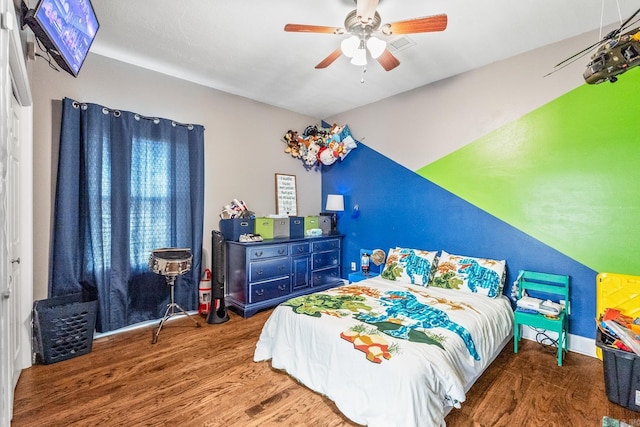 bedroom featuring dark hardwood / wood-style flooring and ceiling fan