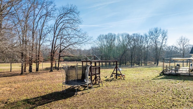 view of yard with a playground and a trampoline