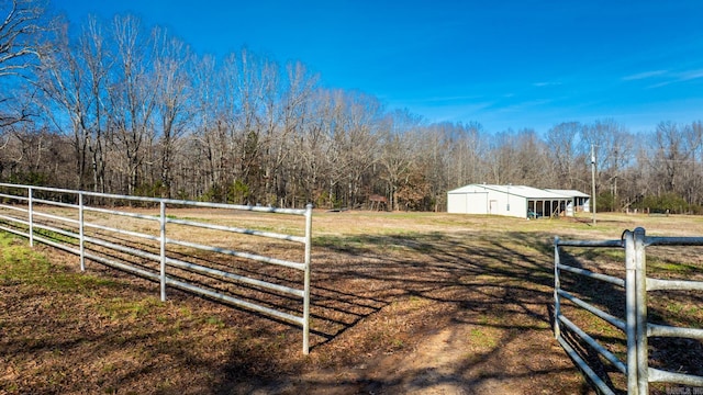 view of yard with a rural view and an outdoor structure