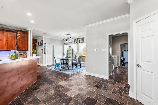 kitchen with independent washer and dryer and crown molding