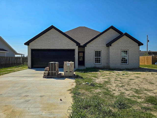 view of front facade with a garage and a front lawn