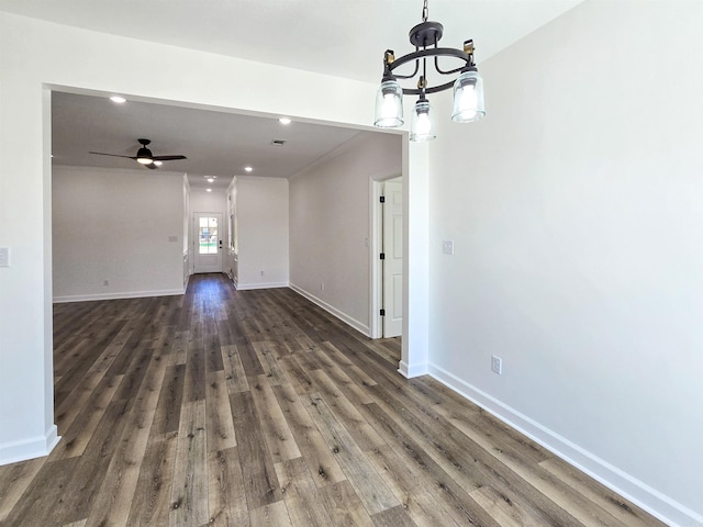 interior space featuring ceiling fan with notable chandelier and dark wood-type flooring