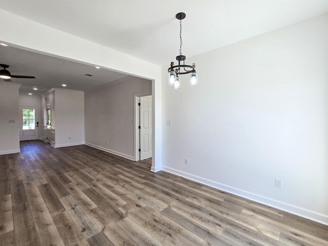 interior space with ceiling fan with notable chandelier and dark hardwood / wood-style flooring