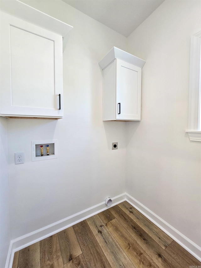 laundry area featuring hookup for an electric dryer, cabinets, hardwood / wood-style floors, and hookup for a washing machine