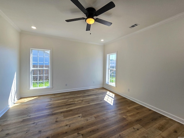 unfurnished room with a wealth of natural light, ceiling fan, dark wood-type flooring, and ornamental molding