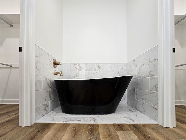 bathroom with a tub to relax in