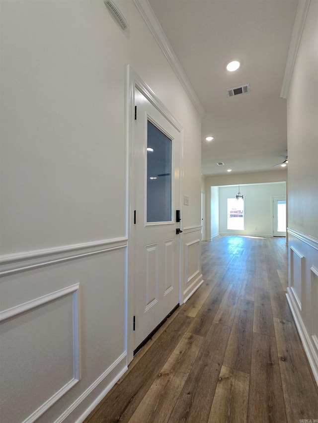 corridor featuring hardwood / wood-style floors and crown molding