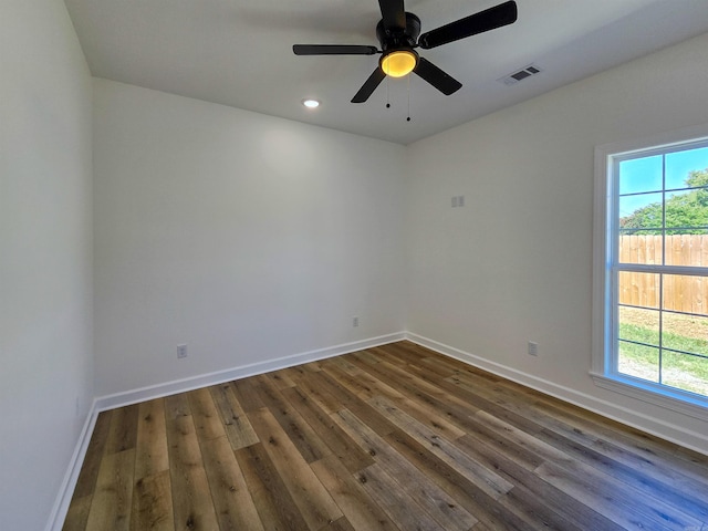 unfurnished room featuring ceiling fan and dark wood-type flooring