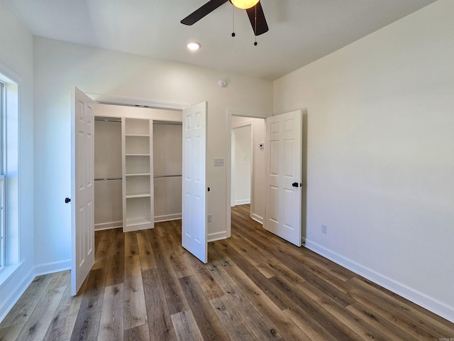 unfurnished bedroom featuring ceiling fan, dark hardwood / wood-style flooring, and a closet