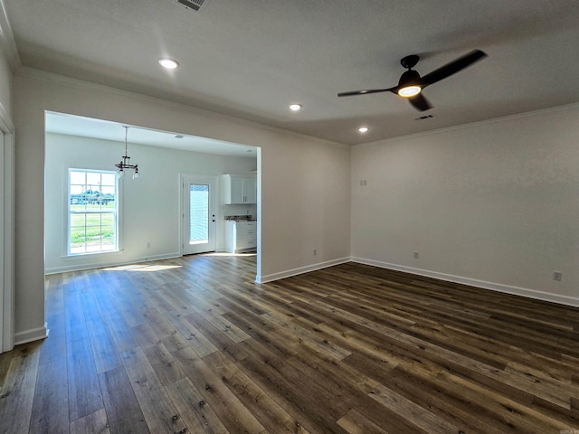 unfurnished room featuring crown molding, dark hardwood / wood-style flooring, and ceiling fan with notable chandelier