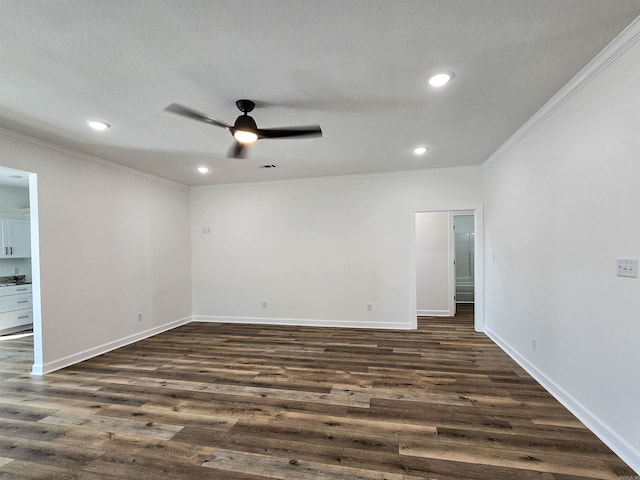 spare room featuring ceiling fan, ornamental molding, and dark wood-type flooring