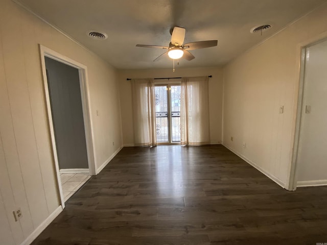 unfurnished room with ceiling fan and dark hardwood / wood-style flooring