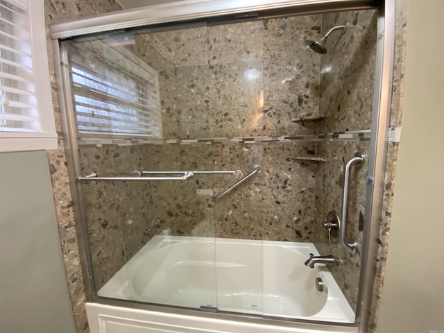 bathroom featuring bath / shower combo with glass door