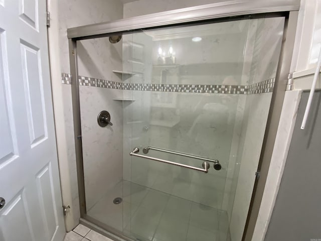 bathroom with tile patterned flooring and a shower with shower door