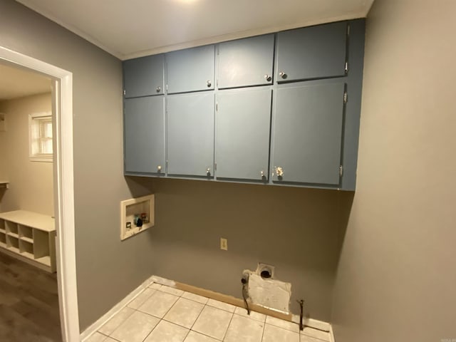 laundry room featuring washer hookup, hookup for an electric dryer, cabinets, and light tile patterned floors