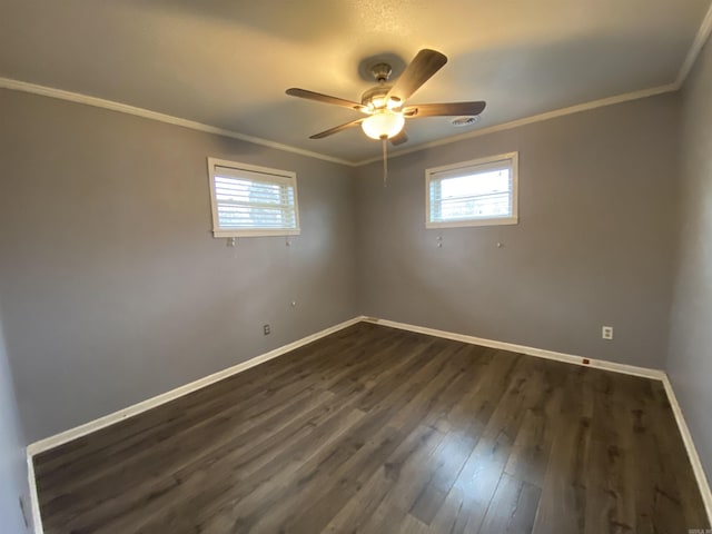 spare room with ceiling fan, crown molding, and dark wood-type flooring