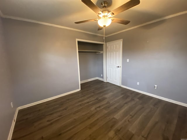 unfurnished bedroom with a closet, dark hardwood / wood-style floors, ceiling fan, and ornamental molding