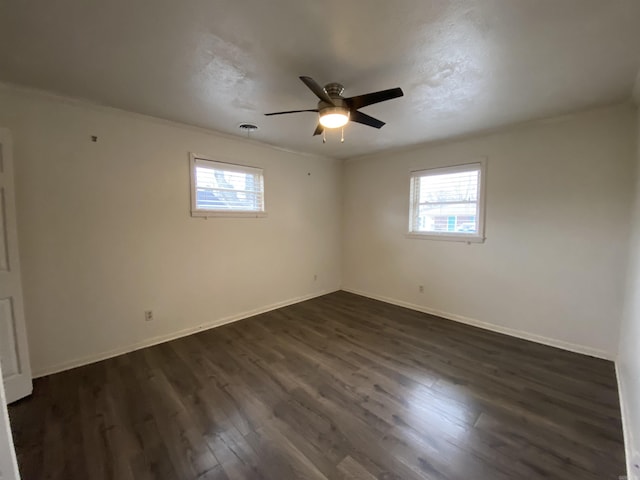 empty room featuring ceiling fan and dark hardwood / wood-style floors