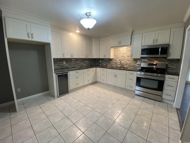 kitchen featuring white cabinets, light tile patterned floors, and stainless steel appliances