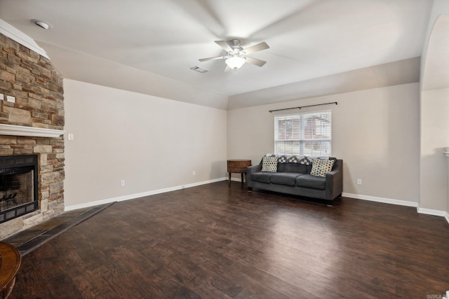 unfurnished living room featuring a stone fireplace, ceiling fan, dark hardwood / wood-style flooring, and lofted ceiling