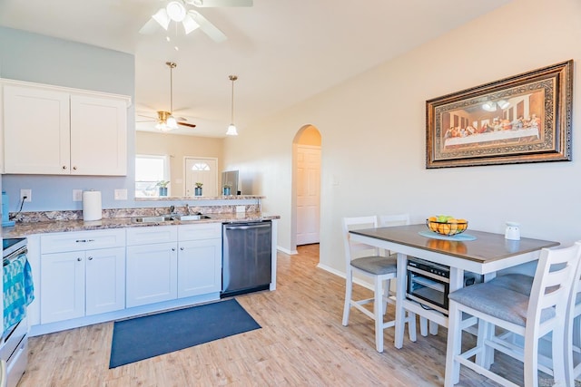 kitchen featuring dishwasher, stove, white cabinets, sink, and light stone countertops