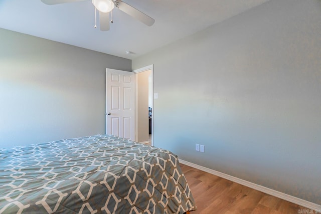 bedroom with ceiling fan and wood-type flooring