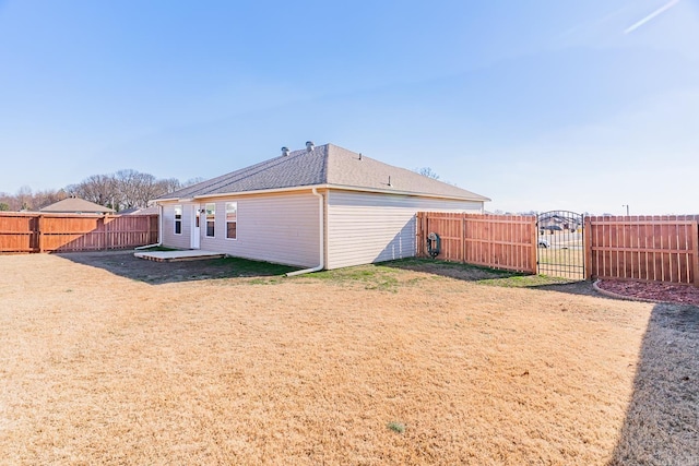 rear view of property featuring a lawn