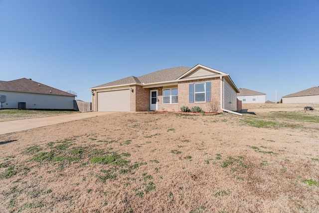 ranch-style home with cooling unit and a garage