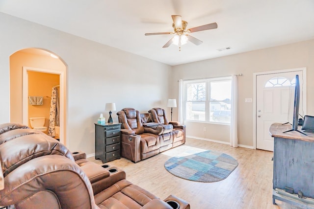 living room with ceiling fan and light hardwood / wood-style flooring