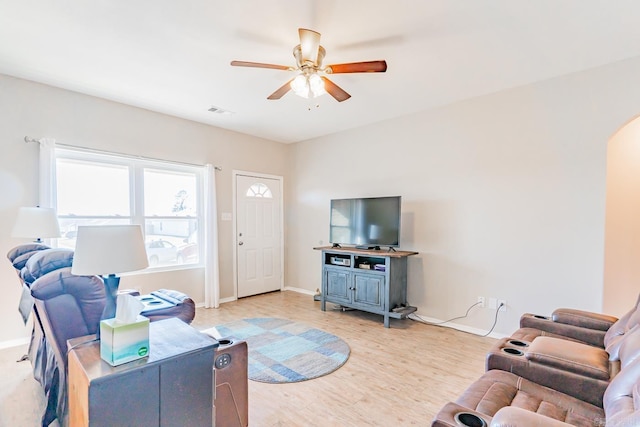 living room featuring ceiling fan and light hardwood / wood-style flooring