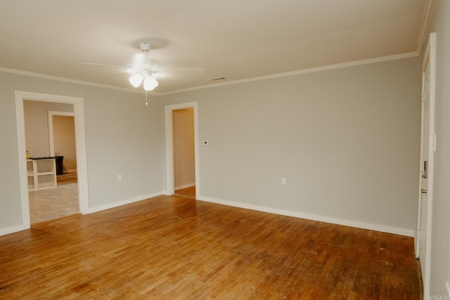 empty room featuring hardwood / wood-style floors, ceiling fan, and ornamental molding