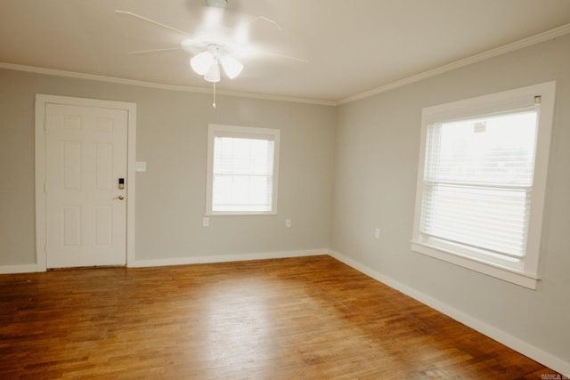 unfurnished room with a wealth of natural light and crown molding