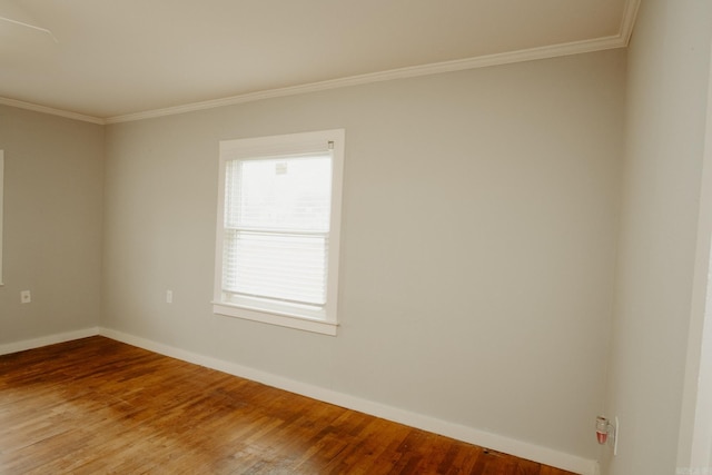 unfurnished room featuring hardwood / wood-style flooring and ornamental molding