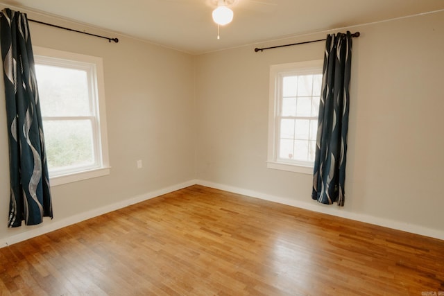 spare room with hardwood / wood-style floors and a wealth of natural light