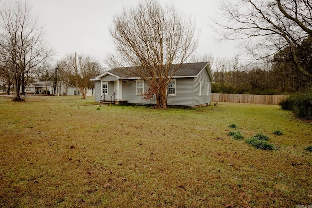 rear view of house with a lawn