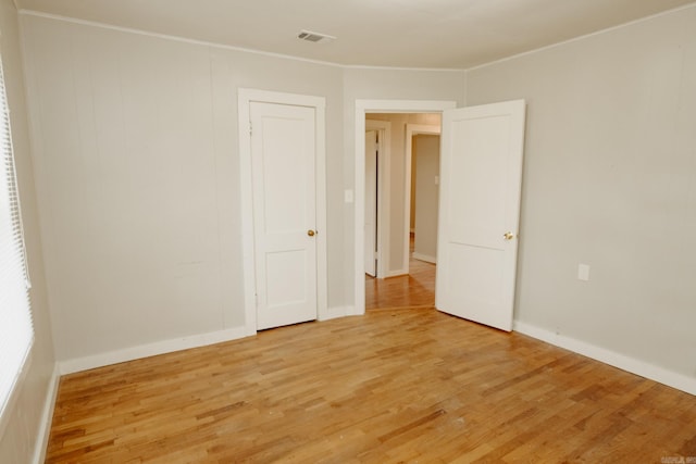 unfurnished room with light wood-type flooring