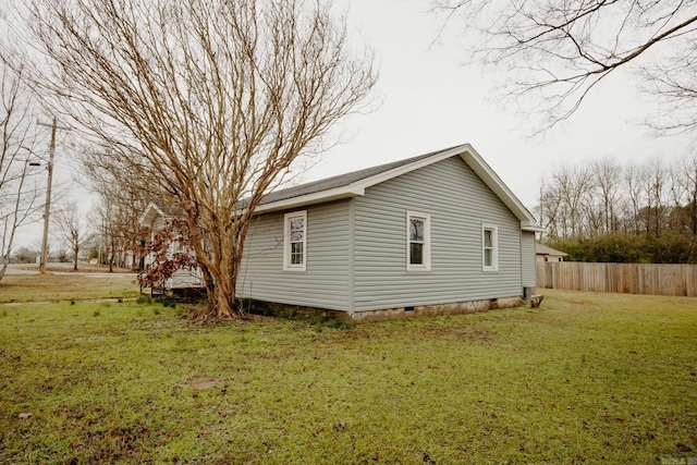 view of side of property with a lawn