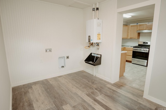 clothes washing area with electric dryer hookup, crown molding, light hardwood / wood-style flooring, washer hookup, and water heater