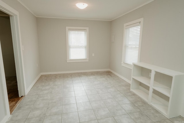 tiled spare room with ornamental molding