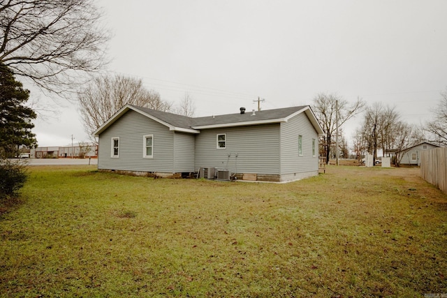 back of house with a lawn