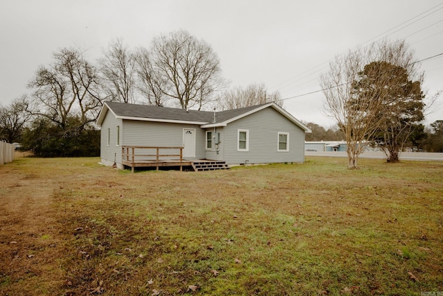 back of house with a lawn and a deck