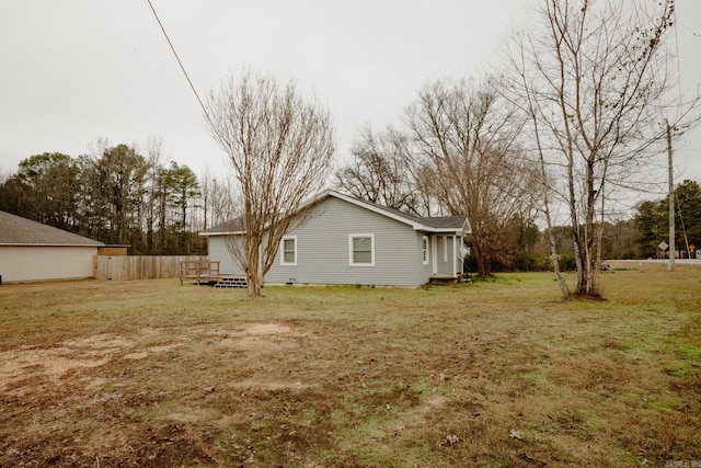 view of side of property with a yard