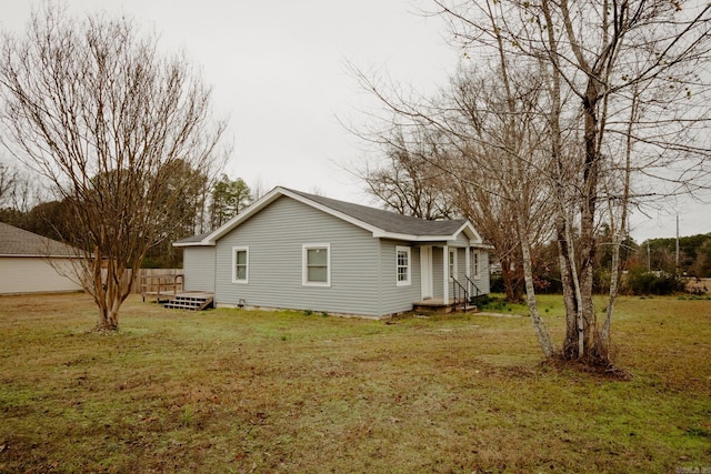 view of side of home with a yard